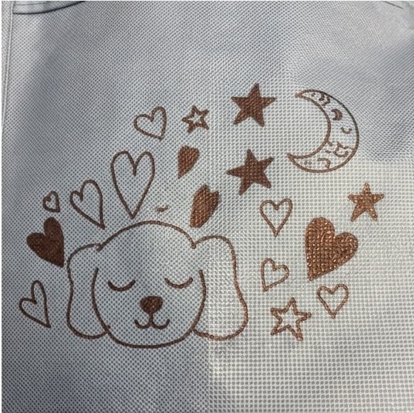A CliniCareBag personalized with a sleeping dog drawing, hearts, stars, and a moon